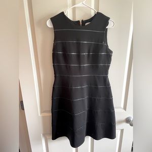 Calvin Klein black women mini dress size 8, hits above the knee. Gold zipper